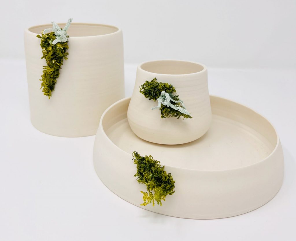 Three porcelain pots with machine embroidered lichen and moss.